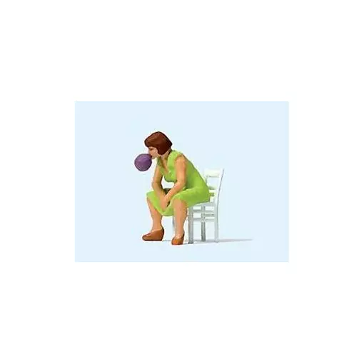 Woman sitting on her chair blowing a bubble